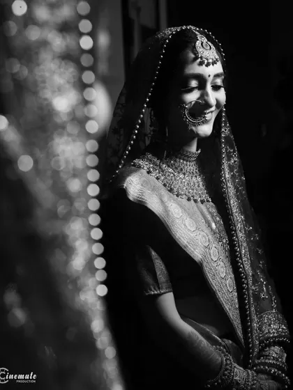 A soft and serene black and white bridal portrait, with bokeh lights adding a gentle sparkle to the background.