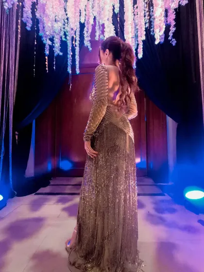 A back view of a stunning golden gown I wore for an anniversary celebration in Thailand. The intricate beading and backless design were pure glamour.