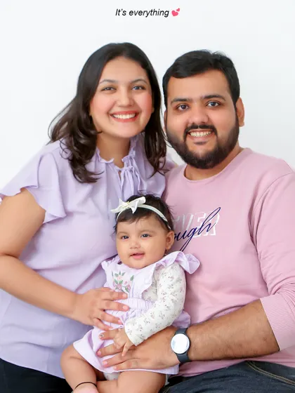 This is the heart of what I do: capturing the pure happiness of a family together. This classic studio portrait focuses on the bright, genuine smiles and the easy connection between parents and their child, creating a timeless memory.
