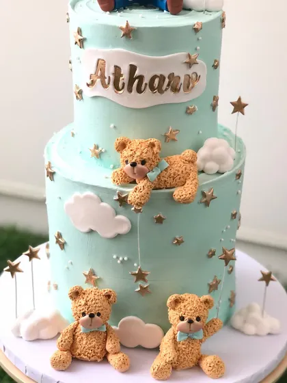 The bottom tier of the two-tiered teddy bear cake, with cute bears playing among the clouds and stars.