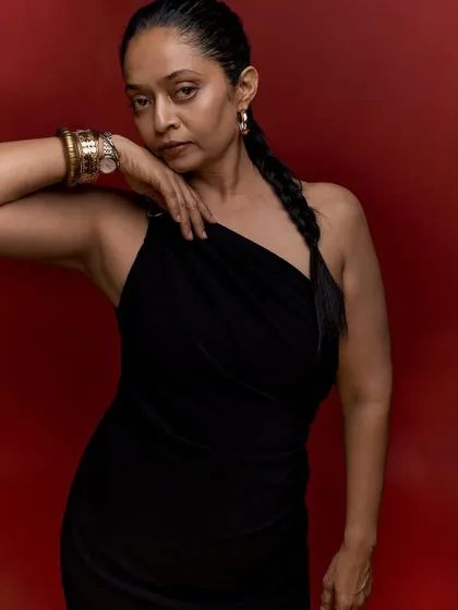 A closer, more intimate portrait from the 50th birthday series. The pose draws attention to the accessories and the subject's expressive features, adding another layer to her story.