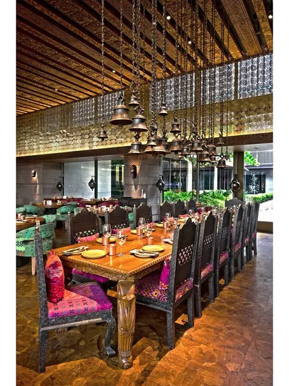 We capture the full scale and ambiance of restaurant interiors. This shot highlights the grand dining area, focusing on the unique lighting fixtures and traditional decor to invite potential diners.