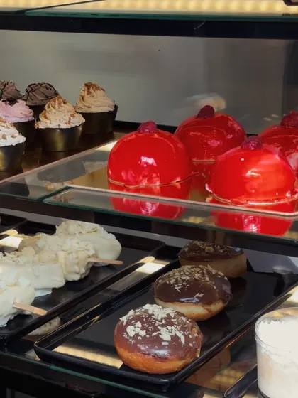 Red glazed heart desserts and cupcakes sit in our chilled display, alongside the day's filled doughnuts.
