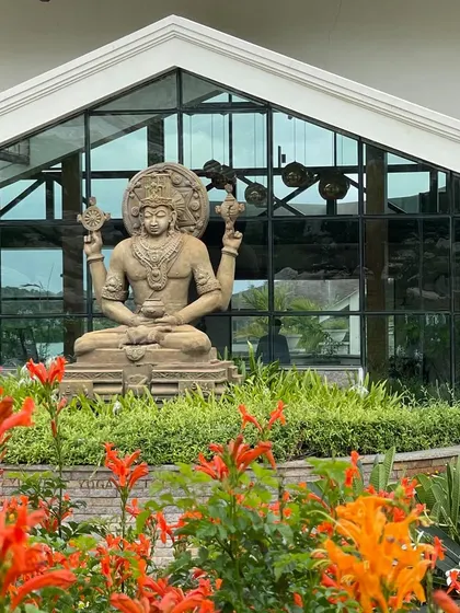 The statue of Lord Dhanvantari, framed by flowers, stands as a powerful symbol of our dedication to the science of Ayurvedic healing.