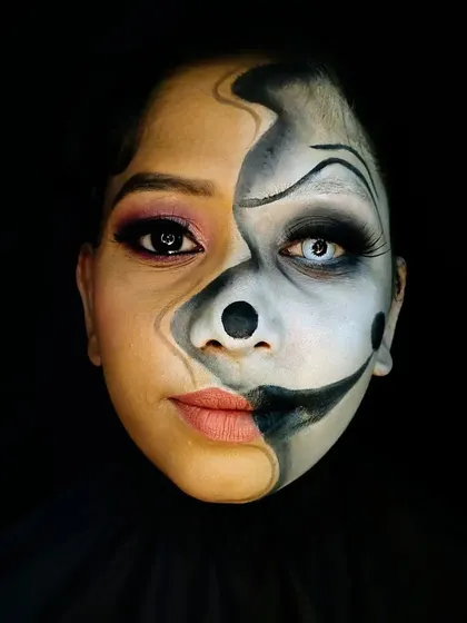 Another take on the two-faced illusion makeup, this time with a slightly different expression and lighting to create a more dramatic effect.