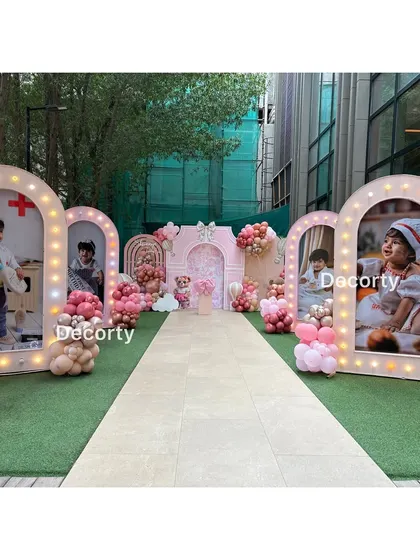 A unique walkway lined with large, illuminated photo frames displaying pictures of the birthday girl. This personal gallery was a highlight of the Ralph Lauren-themed celebration.