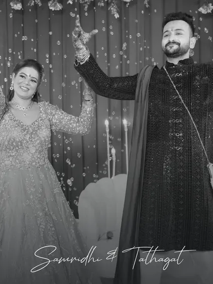 A candid moment of pure joy. This black and white photo captures the couple dancing, surrounded by bubbles, showcasing the fun and celebratory atmosphere we create.