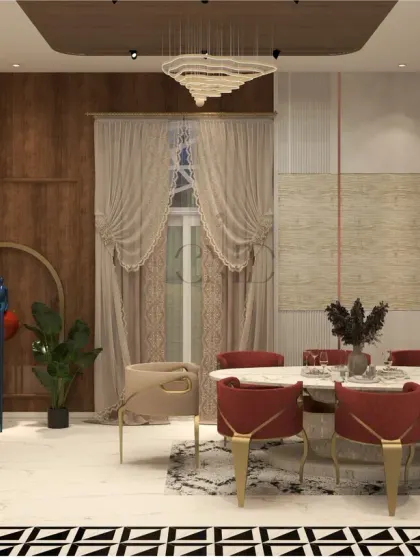 The dining area in the Noida penthouse features rich rust-orange chairs and a leaf-shaped marble table, set against a backdrop of textured walls and rose gold accents.