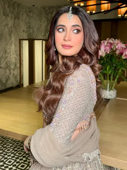 Exotic and elegant, an irresistible combination. This stunning reception look features a soft glam makeup style that complements the intricate, embellished lehenga.