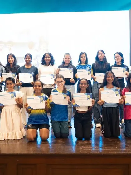 Our girls' teams proudly display their certificates on stage during the Bravo Xcelerate Annual Awards Day. This image captures a moment of recognition for their hard work and success throughout the season.