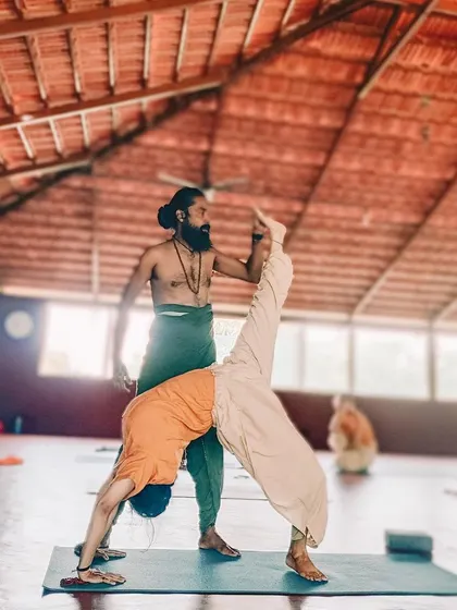 Nothing is impossible with dedication and the right guidance. Here, I assist a student in a one-legged downward dog split, helping them reach for new heights in their practice.