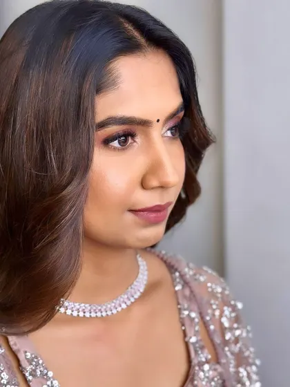 A soft and pretty party look for Rachana. The pink-toned eyeshadow and simple diamond necklace create a modern and chic style for a family event.