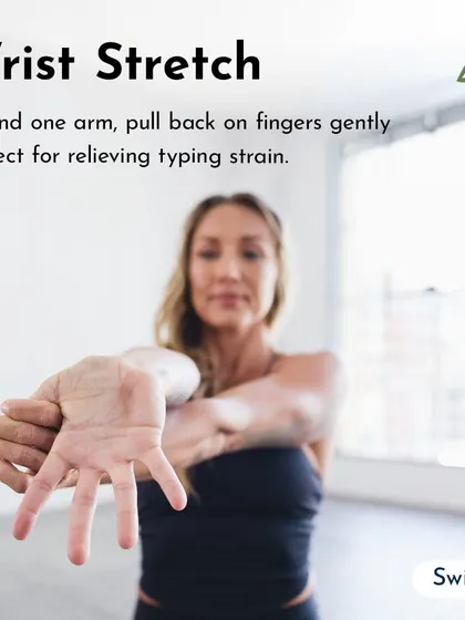 A wrist stretch is essential for anyone who types a lot. Extend one arm and gently pull back on the fingers to relieve strain.