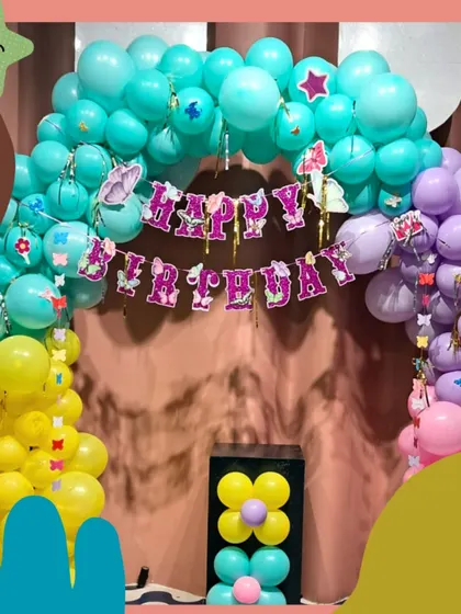 A rainbow of fun! This colorful butterfly-themed balloon arch is perfect for a bright and cheerful birthday celebration.