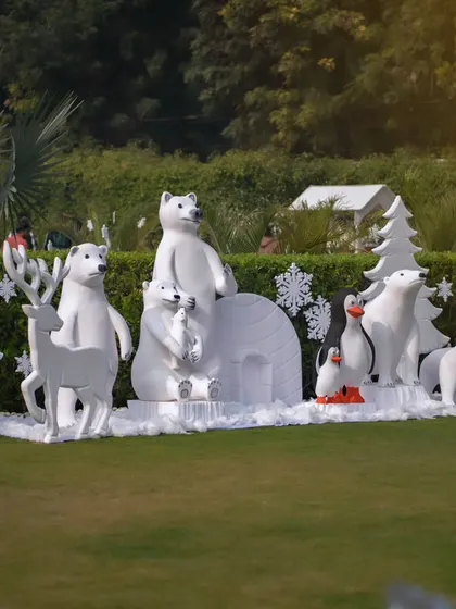 A wider view of the winter animal props, showing how they transform a green lawn into a snowy, arctic landscape.