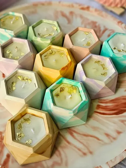 A collection of my hexagon-shaped soy wax candles in various pastel marble patterns. Each one is topped with gold foil for a touch of elegance. These are perfect for gifting or adding a pop of color to your decor.