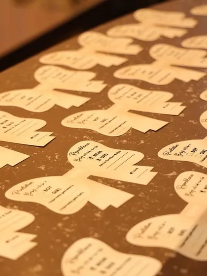 Bow-shaped prediction cards ready for guests to share their well wishes.