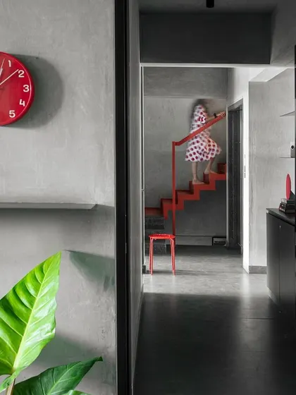 A nonchalant red staircase creates a diaphanous connection between the two floors of our studio. We use streaks of color like this throughout the office as distractions, drawing attention to specific elements and circulation paths.