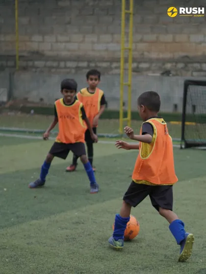 Young players learn defensive positioning in a training drill.