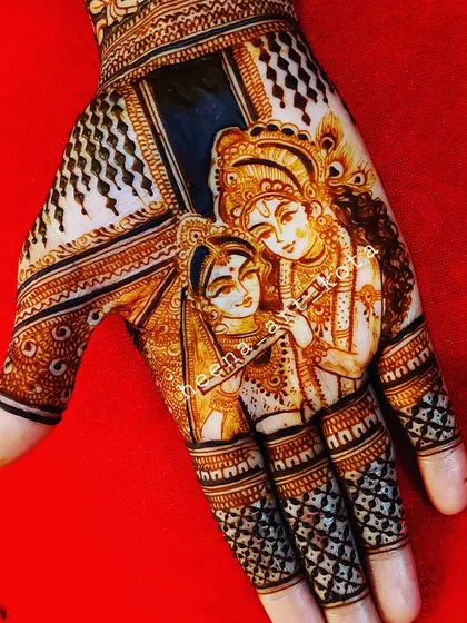 A beautiful Radha Krishna portrait on the palm, using negative space to make the figures stand out.