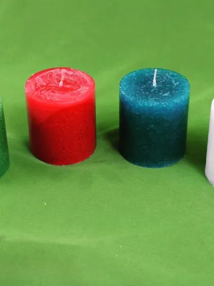 This photo shows the green, red, blue, and white small pillar candles together. It helps customers visualize how the colors look side-by-side.