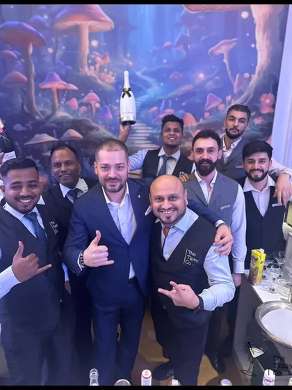 Our team with a happy client at an event with a whimsical, fantasy-themed backdrop. We are proud to be part of such creative and unique celebrations.
