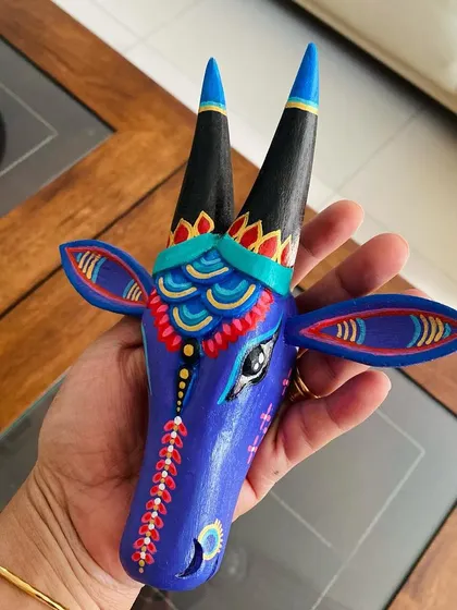 A close-up of the custom blue Nandi, showing the fine lines and layered colors that make it a special piece.