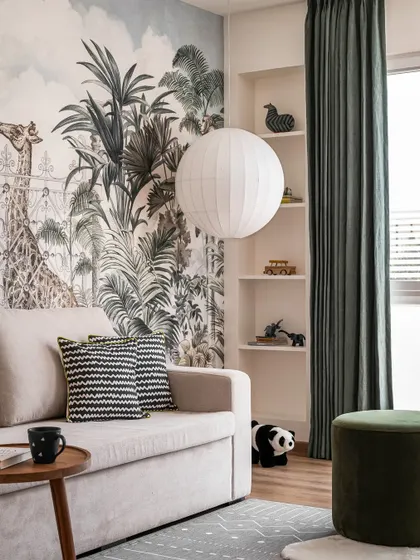 The kids' room in the Aqua Home, where a large spherical paper lantern provides a soft, playful light source that complements the jungle mural.