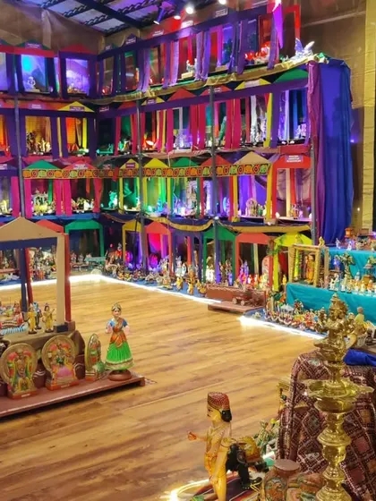 The doll exhibition hall illuminated with colourful lights, creating a festive and magical atmosphere. This view shows the variety of display styles we use to engage our visitors.
