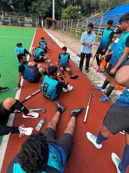 The team listens intently to the coach during a break in the action. These moments of guidance are crucial for making in-game adjustments and maintaining focus.