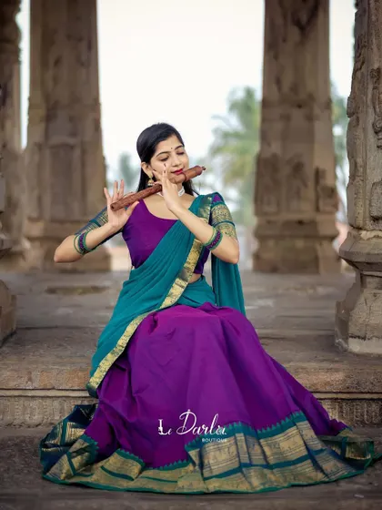 A series of photos from a collaboration with a designer, showcasing a beautiful half-saree against the backdrop of ancient temple pillars. I love how the vibrant colors of the costume stand out.