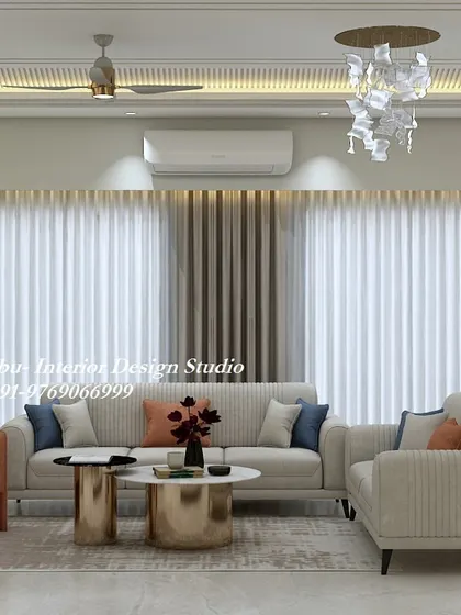 This living room uses a simple color palette of cream and orange to create a warm and inviting space. The vertically-striped sofas and metallic coffee tables add a touch of modern flair.