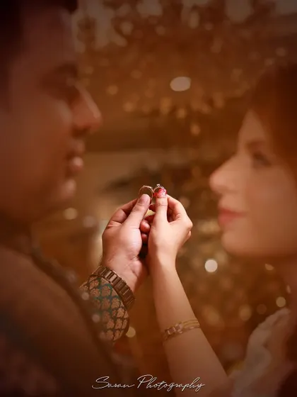 A soft-focus, artistic shot of a couple holding their engagement rings together.
