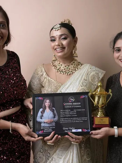 A proud moment with a graduate who excelled in her final exam, creating a beautiful white and gold bridal look.