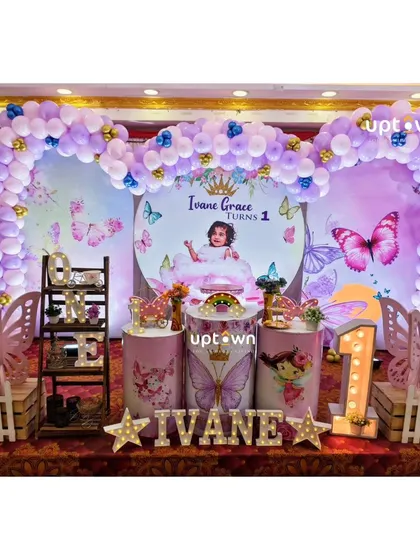 Another view of Ivane's butterfly party, showing the light-up name and number '1'.