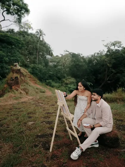 A serene moment from the pre-wedding shoot, where the couple shares a quiet connection amidst nature. The lush greenery provides a beautiful contrast to their calm presence.