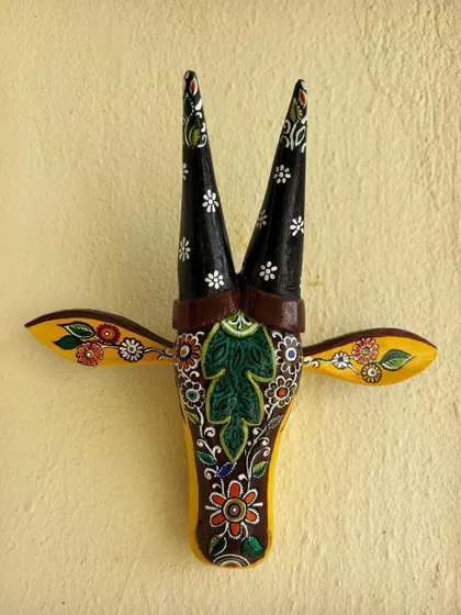 A frontal view of the yellow Kalamkari Nandi, showcasing the complete design and the harmony of the colors.