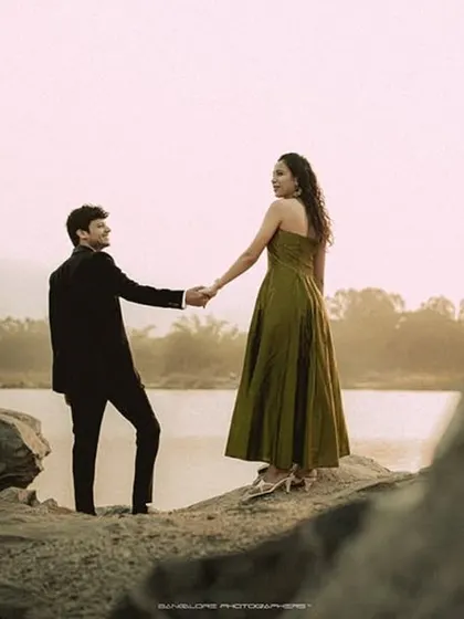 A dramatic pre-wedding shot of the couple walking in a vast, rocky landscape. It tells a story of adventure and journeying together.
