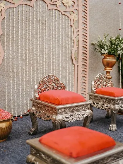 A closer look at the beautiful silver chairs and the detailed carving of the backdrop, key elements of our Indo-Western traditional decor.