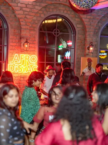 The party in full swing. This photo shows the packed venue and the diverse crowd that comes together for the love of Afro and Latin beats.