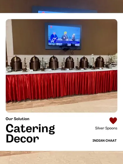 A stylish catering decor setup for an Indian Chaat event. The long buffet table with a red skirt and elegant, uniform serving dishes creates a professional and visually appealing look.