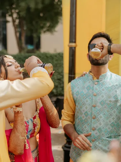A fun, candid moment of the couple taking a celebratory shot together. These are the memories that last a lifetime.