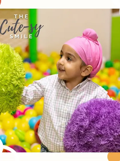 The cute-sy smile. This little guest is having a wonderful time exploring the textures and colors in our ball pit.