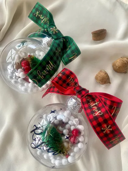 'Tis the season to celebrate. I love creating these personalized transparent Christmas baubles, filled with festive cheer and adorned with a name in calligraphy and a classic plaid ribbon.