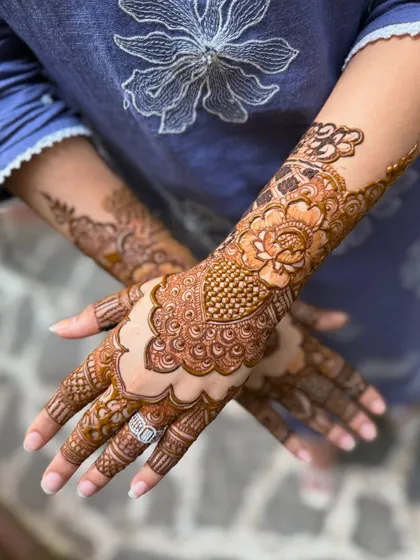 A close-up of the non-bridal henna, highlighting the intricate details on the hand and the beautiful ring.