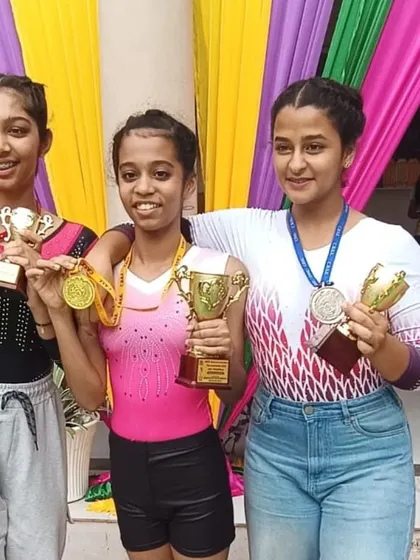 More moments of triumph from various competitions, showcasing our gymnasts with their medals, trophies, and proud coaches.
