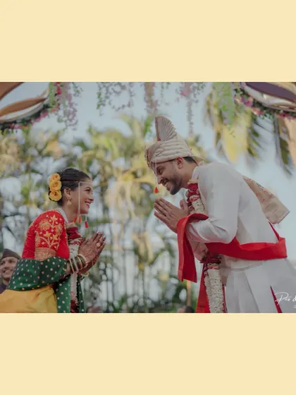 A moment of mutual respect and happiness as the bride and groom greet each other with a 'namaste' during their wedding ceremony.