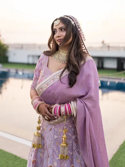 A beautiful three-quarter portrait of the bride, capturing the elegance of her posture and the soft light of dusk.