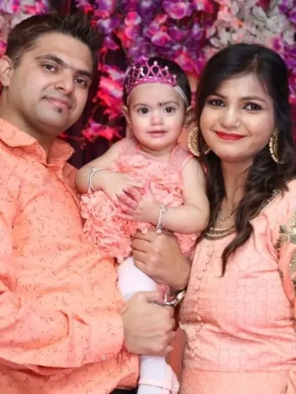 A family wearing matching peach outfits for their daughter's birthday celebration. We love when families coordinate, and we make sure to capture it beautifully.