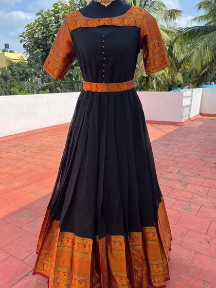 The simple elegance of this traditional gown makes it a versatile choice.